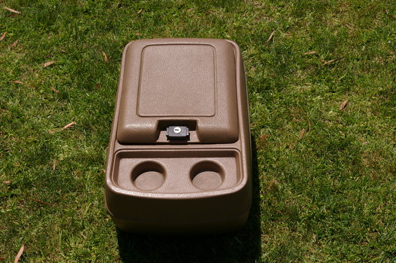 Brown plastic center console with two cup holders and a latching lid