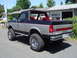 1989 Ford Bronco - This 1989 Ford Bronco features a two-tone paint scheme and lifted suspension with large off-road tires.