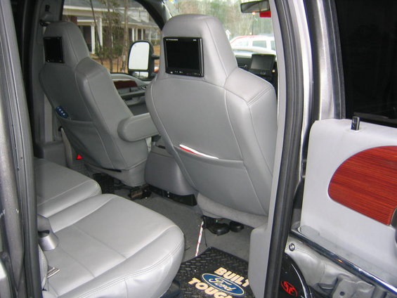 Interior of a 2005 Ford F-250 with gray leather seats and headrest screens