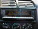 1994 Ford Probe - Close-up of a car's dashboard climate controls and a radio display.