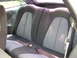 1994 Ford Probe - The rear seats of the vehicle are visible, patterned upholstery and seatbelt mechanisms.