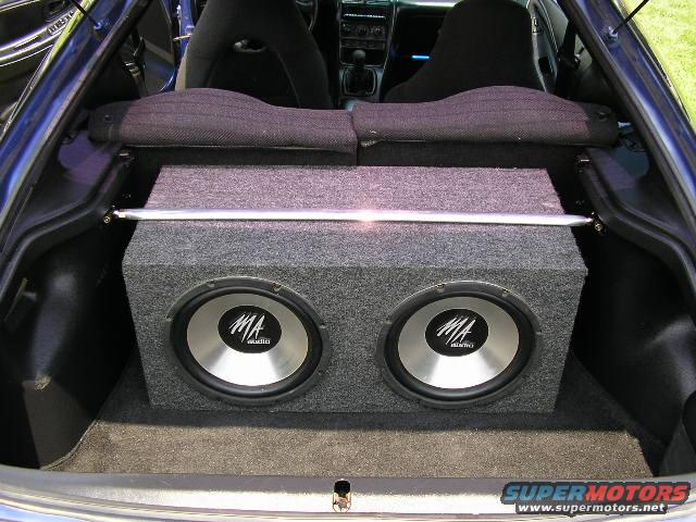 Blue 1994 Ford Probe trunk interior with dual MA Audio subwoofers in a grey carpeted box