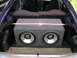 1994 Ford Probe - The trunk of a blue 1994 Ford Probe houses a dual subwoofer enclosure.