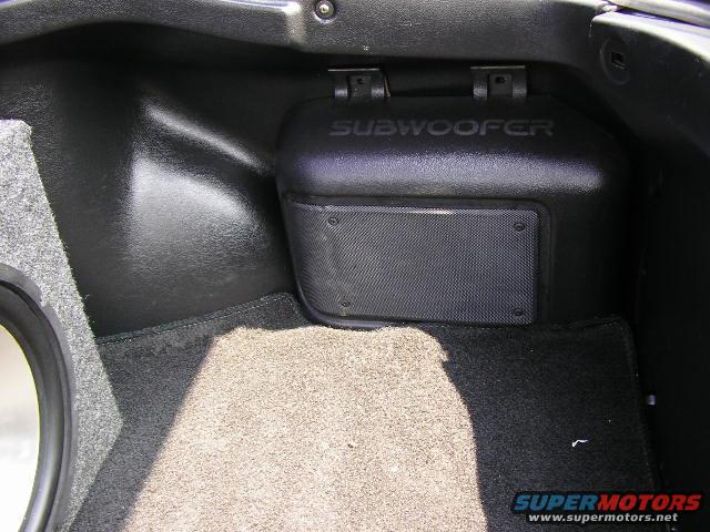 Subwoofer enclosure in trunk with 'SUBWOOFER' text