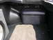 1994 Ford Probe - The trunk of a vehicle features a black subwoofer enclosure with the word 'SUBWOOFER' embossed on top.