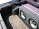 1994 Ford Probe - Subwoofer box installed in the trunk of a car, with a metal strut bar above it.