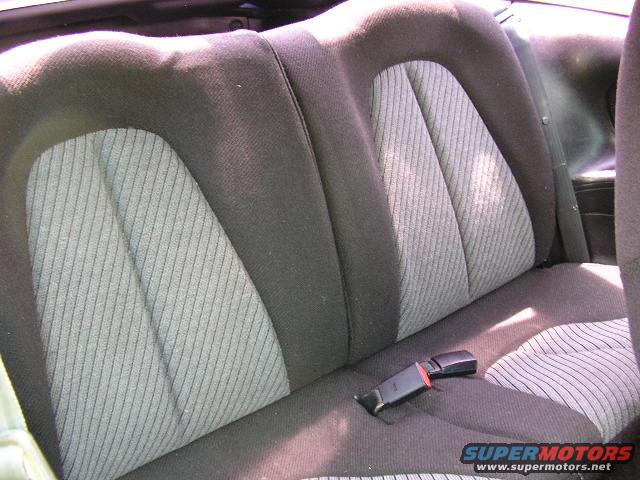Rear seat with patterned fabric inserts and a black seatbelt buckle