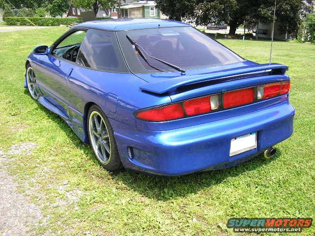 Blue 1994 Ford Probe GT parked on grass, rear 3/4 view