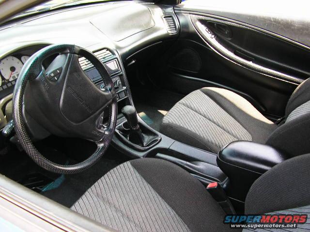 1994 Ford Probe interior with cloth seats, black dashboard, and steering wheel with 'PROBE' embossed