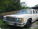 1985 Ford Crown Victoria LTD - This 1985 Ford Crown Victoria LTD is seen from a 3q-front angle, a prominent blue hood scoop.
