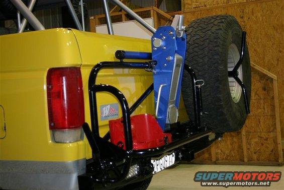 Yellow 1984 Ford Bronco rear with spare tire carrier, jack, and red fuel can