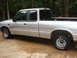 1994 Mazda B3000 - This silver pickup truck has a dual cab and pinstripe graphics. The body style suggests a mid-1990s model year.