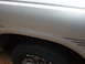 1994 Mazda B3000 - Close-up view of a silver truck fender and tire, pinstripe graphics and 'Radial' text on the tire sidewall.