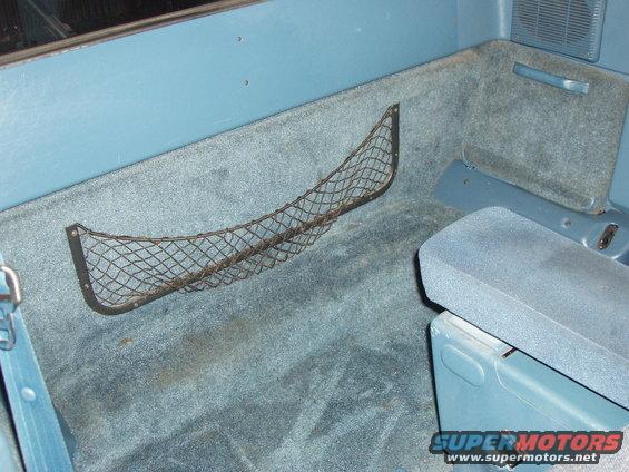 Interior cargo net and seat in a blue vehicle
