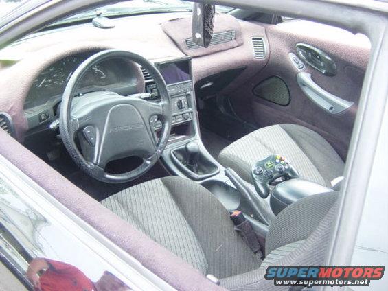 1995 Ford Probe interior with steering wheel, dashboard, and game controller