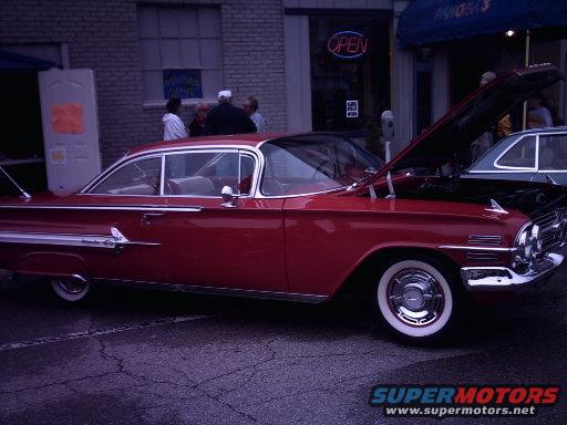 Red 1959 Chevrolet Impala coupe with hood open, white wall tires, and chrome trim