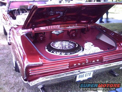 Red 1966 Pontiac GTO convertible rear view with open trunk