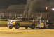 2000 Ford F-250 - Ford F-250 truck competes in a pull event, generating significant exhaust smoke.