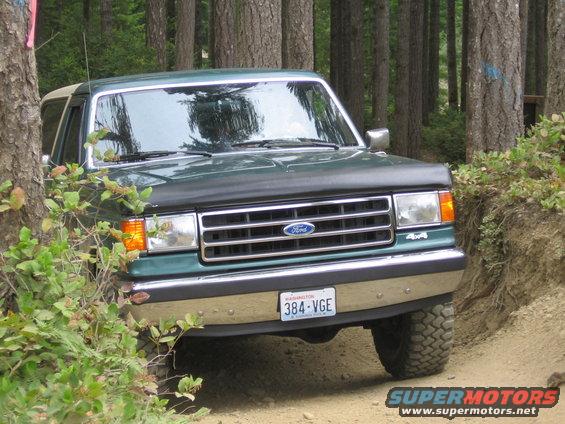 1990 Ford Bronco 4x4 on a dirt road in a forest, Washington license plate 384-VGE