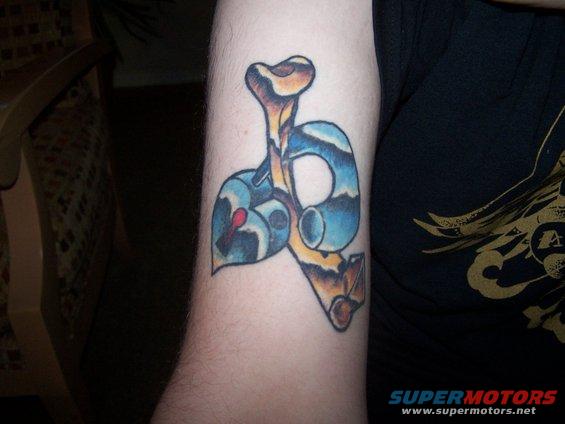 Tattoo on an arm showing a stylized bone and heart design with blue and brown colors