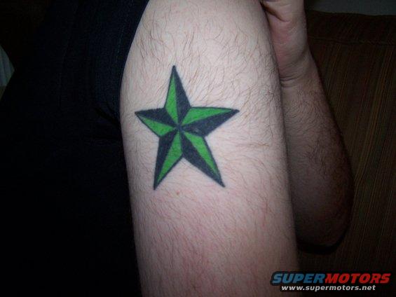 Arm with a green and black star tattoo. Supermotors.net logo in corner
