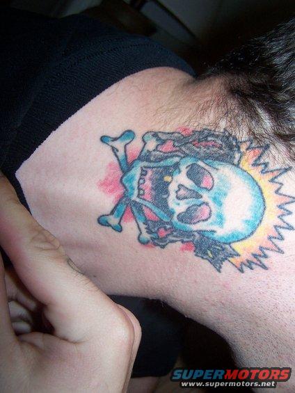 Skull and crossbones tattoo on neck with "SUPERMOTORS.NET" text visible