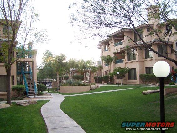 Apartment buildings with a walkway through a grassy courtyard