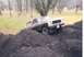 1979 Ford Bronco - A Ford Bronco navigates a steep incline of loose soil.