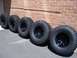 1996 Jeep Grand Cherokee - A set of five off-road tires are displayed against a brick wall, with a watermark at the bottom right.