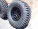 1996 Jeep Grand Cherokee - Close-up of Mickey Thompson Baja MTZ off-road tires mounted on black rims.