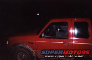 Red 1997 Ford Ranger extended cab pickup truck, side view at night