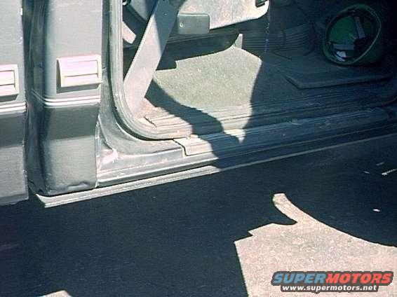 pict0116.jpg Custom rocker panel 1/4" skid plate attached to floor for maximum ground clearance.  Is strong enough to support truck.