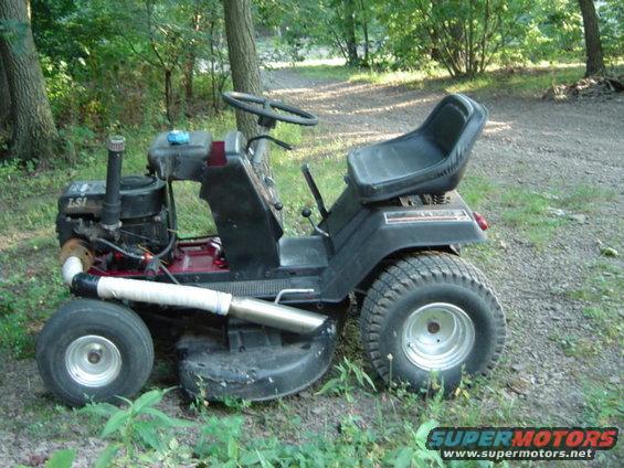 Black lawn tractor with a modified exhaust pipe, seen from the side