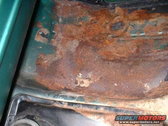 Rusted out passenger's side floor.