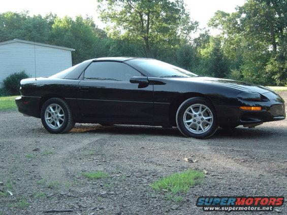 Black 2002 Chevrolet Camaro parked on a gravel lot, side view