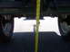 1991 Ford Bronco - Underside view of a green vehicle with a measuring tape indicating clearance.