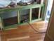 1994 Ford F-150 - The interior of a camper shows unfinished wooden framing and a black power cord running across the floor.