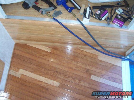 Interior flooring with nail guns and hoses