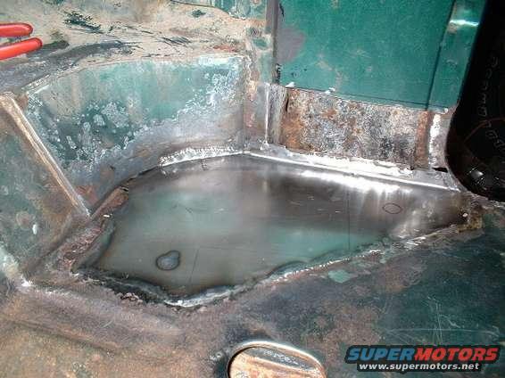 oct00055.jpg Driver's side, patch made over rusted floor area.