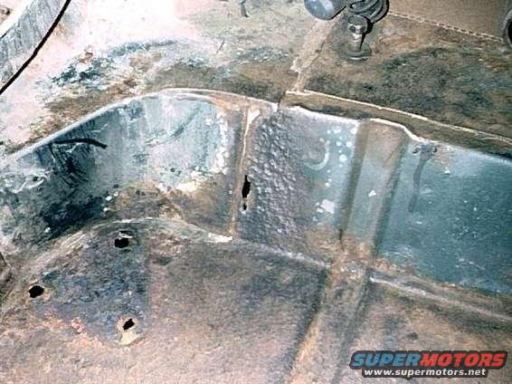 Passenger side corner, rusted areas.