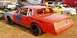 1966 Ford Fairlane - This modified sedan, likely prepared for demolition derby, is seen from a 3/4 front perspective with visible racing modifications.
