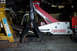 1995 Ford Taurus - Underneath view of a vehicle's engine bay, secured by jack stands and a floor jack for maintenance.