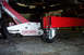 1995 Ford Taurus - Engine hoist and jack are positioned under the vehicle for support during maintenance.
