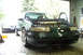 1995 Ford Taurus - A green Ford Taurus sits in a garage with its hood open, and another car is visible in the background.