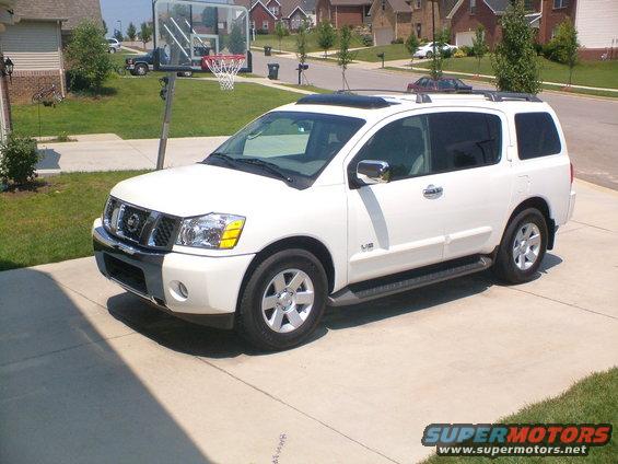 White Nissan Armada parked in driveway with basketball hoop nearby