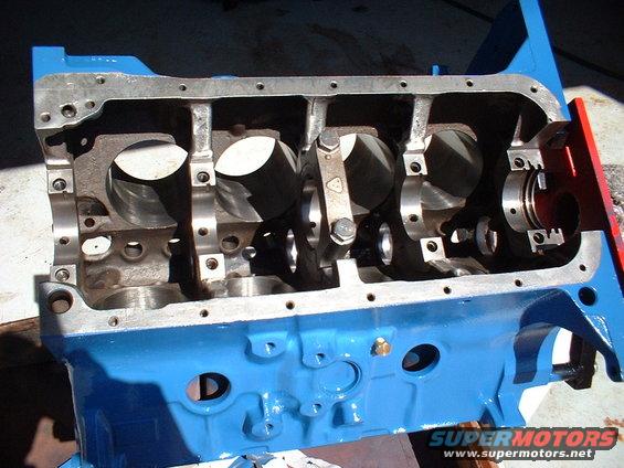 Engine block with crankshaft bearings visible. Blue painted block with silver metal parts