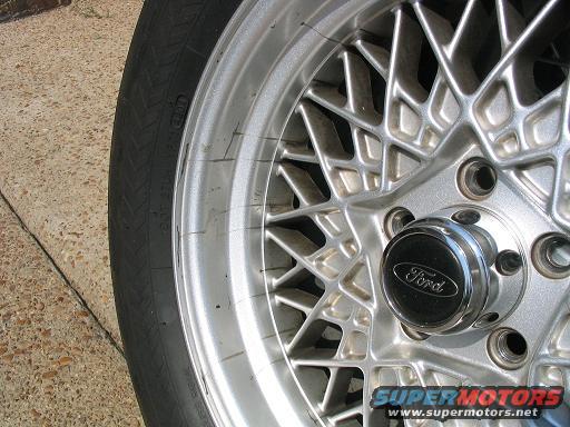 Close-up of a silver mesh wheel with a black Ford center cap