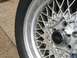 1999 Ford Crown Victoria - Close-up of a silver mesh wheel with a black Ford center cap and tire.