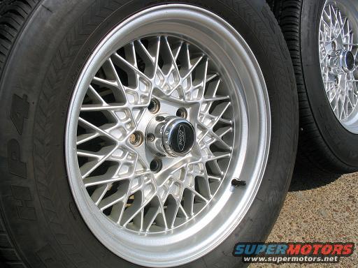 Silver mesh wheels with Ford logos and tires