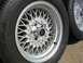 1999 Ford Crown Victoria - Close-up view of silver mesh wheels, one a Ford logo center cap, alongside tires.
